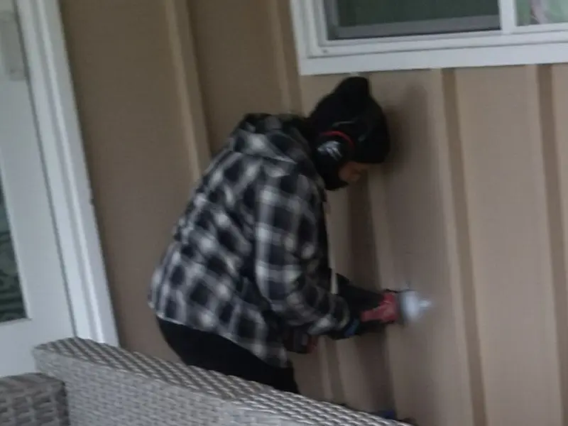 Professional electrician installing an exterior outlet in Chaffee